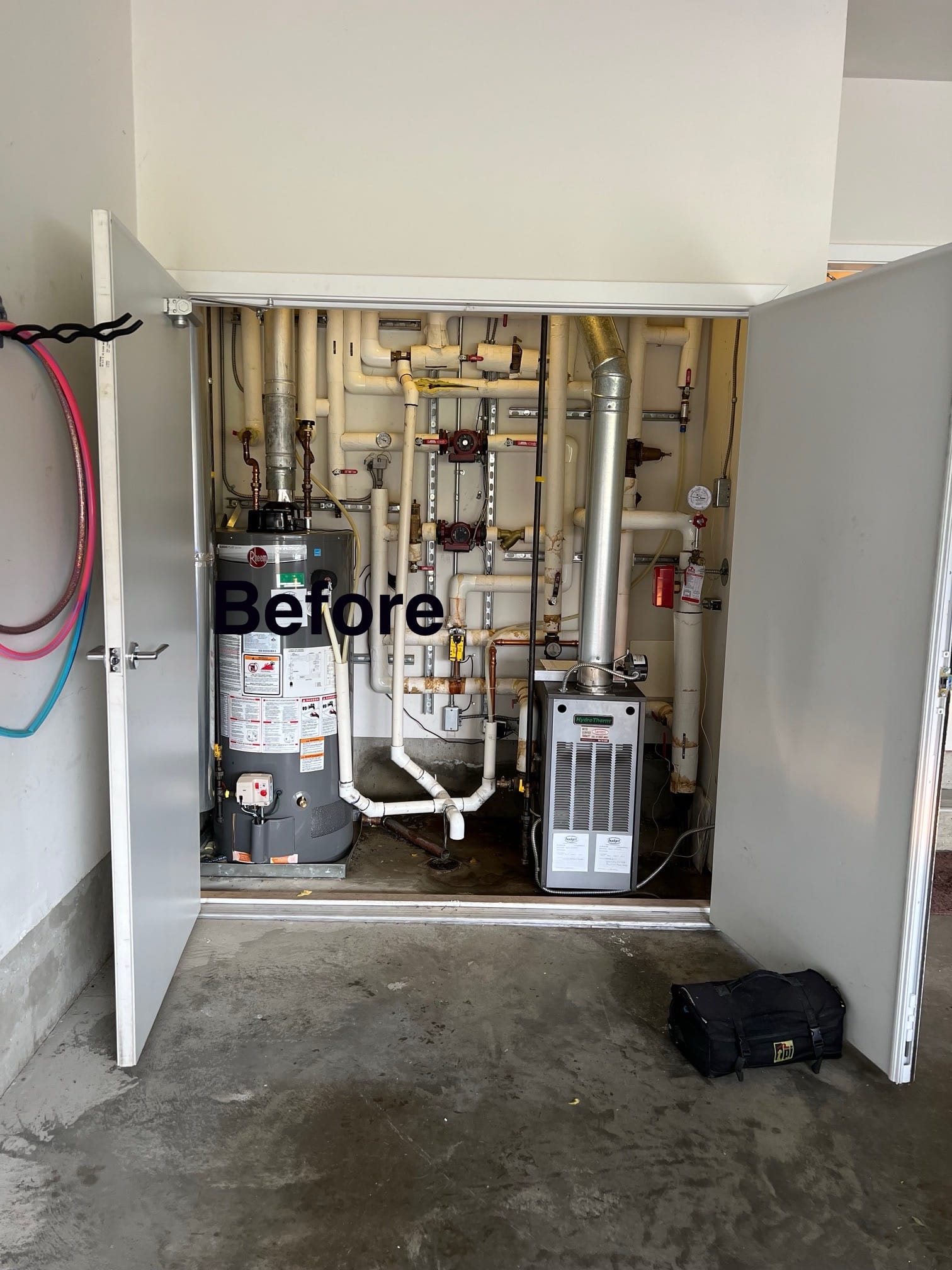 Older hydronic boiler and storage water-heater system before replacement