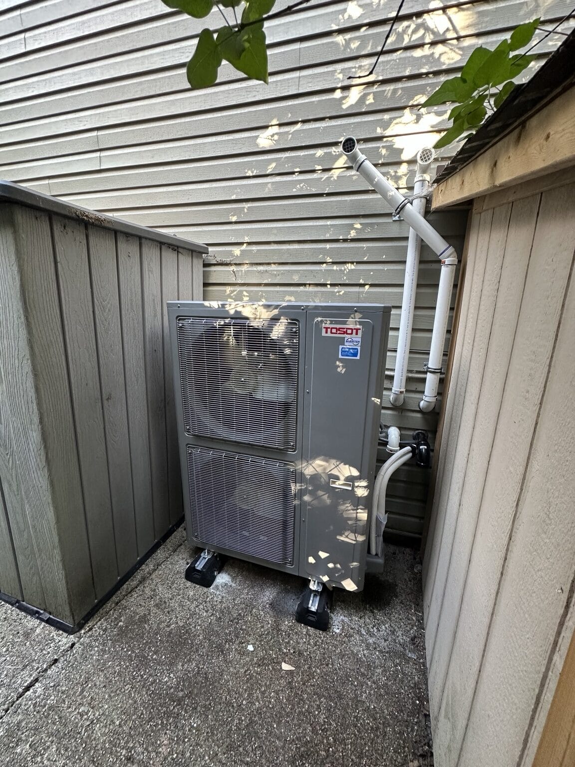 TOSOT central heat pump installed beside a home by Perfect Choice Heating and Cooling.