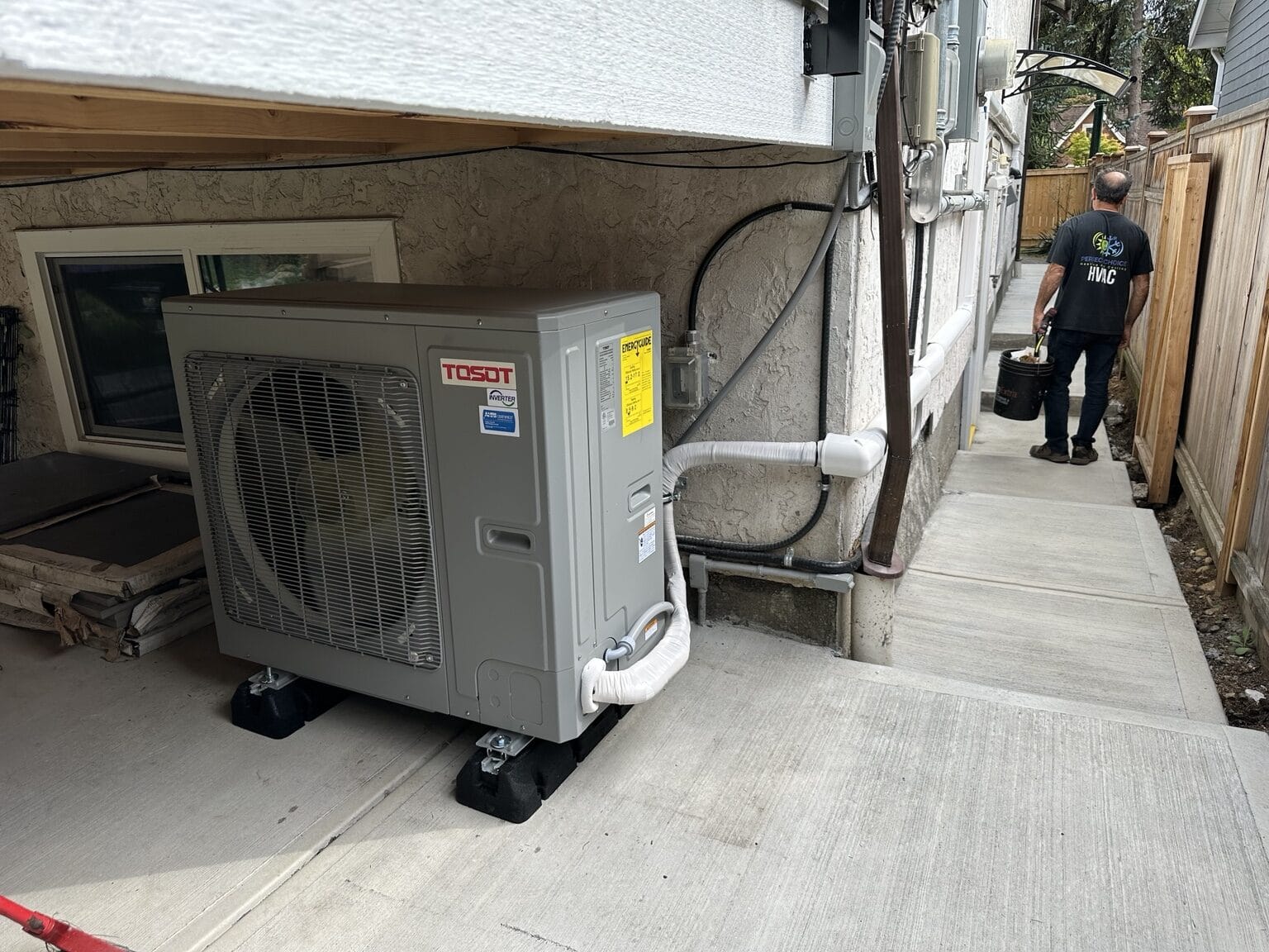 TOSOT central heat pump installed beside a home by Perfect Choice HVAC.
