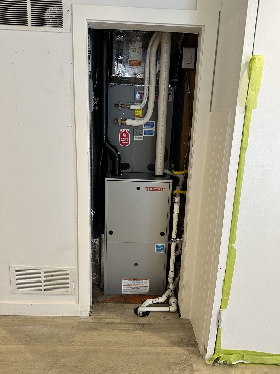 TOSOT furnace and air handler installed in a finished residential closet.