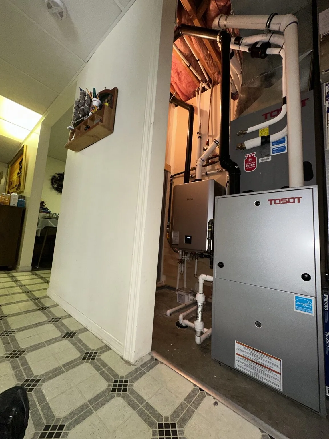 TOSOT furnace and air handler installation in a residential utility space.